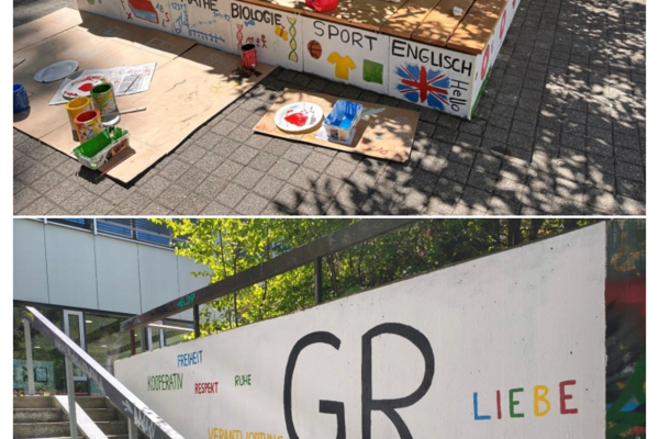 Eine Sitzbank mit bunten Malereien von Fächern und Symbolen, daneben eine Wand mit den Worten Freiheit, Respekt und Liebe.